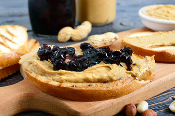 Crispy toast with peanut butter and berry jam. Traditional American breakfast.
