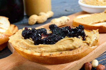 Crispy toast with peanut butter and berry jam. Traditional American breakfast.