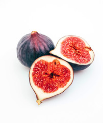 A set of ripe blue figs, whole, cut and sliced, isolated on white background. Healthy dieting concept.
