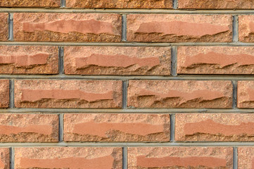 Fototapeta premium Wall of red brick. Concrete fence. Textural background. Close-up.
