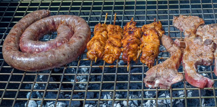 Meat on the grill in a traditional South African braai image with copy space in landscape format