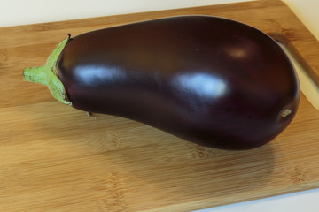 Fresh ripe eggplant over the cutting board.
