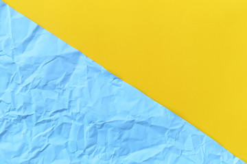 blue arctic color of crumpled or wrinkled and yellow paper background.