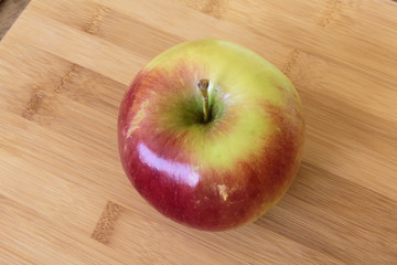 Juicy apple isolated on wooden background.