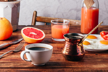Breakfast with coffee and fried eggs