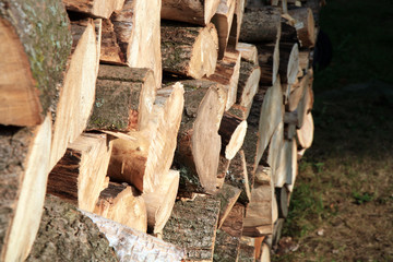 Pile of firewood. Preparation of firewood for the winter at an old farm house on the farm.