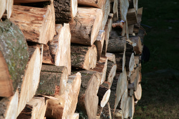 Pile of firewood. Preparation of firewood for the winter at an old farm house on the farm.