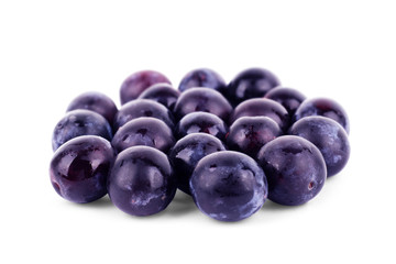 Fresh little plums on a white background