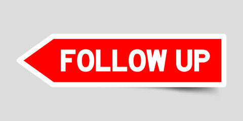 Red color arrow sticker with word follow up on gray background