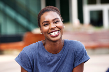 Close up beautiful young african american woman smiling outdoors