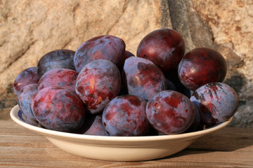 Plums from home orchard. Tasty and healthy snack on the farm. Set of fruits in the countryside.