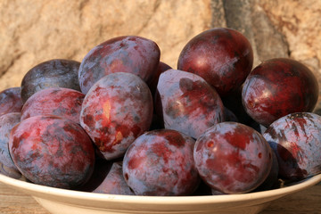 Plums from home orchard. Tasty and healthy snack on the farm. Set of fruits in the countryside.