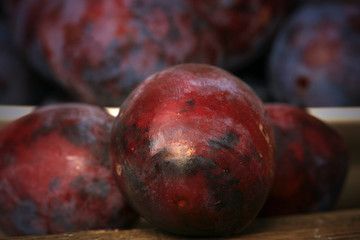 Plums from home orchard. Tasty and healthy snack on the farm. Set of fruits in the countryside.