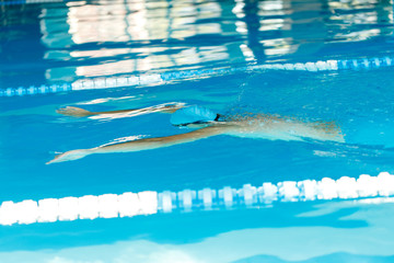Image of sportsman swimming under water in pool