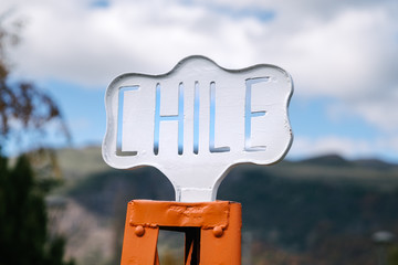An old Chile street sign in a town square in Lonquimay, Chile.