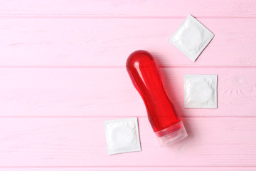 an intimate lubricant on a colored wooden background. Intimate gel, comfortable sex.