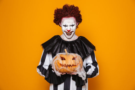 Mad man dressed in scary clown Halloween costume