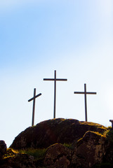Three big Christian crosses outside in blue sky