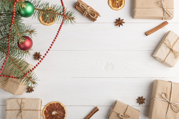 Craft gifts under the tree, on the table, against the white background. The concept of Christmas and New Year. Copy space.