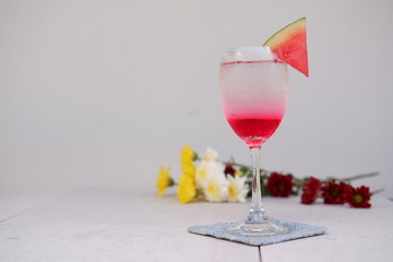 glass of cocktail with cherry on white background