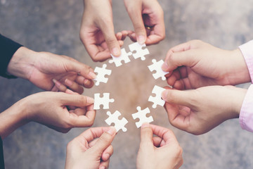 team hand placing the  jigsaw puzzle piece for connect business partner and connection solution ...
