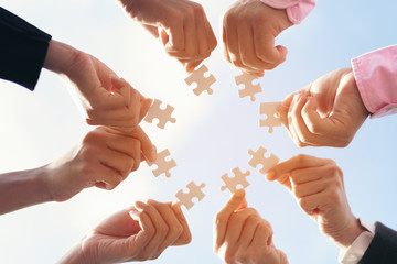 team hand power full placing the  jigsaw puzzle piece for connect business partner and connection solution  concept worker  unity team. Digital nomad team partner