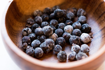 Black Raw Tapioca Pearls in Wooden Bowl.