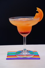 orange margarita on wood table
