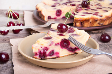 Piece of sweet cherry clafouti. Summer pie.