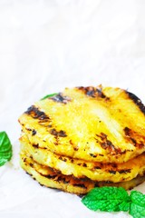 Grilled Pineapple rings on white background, selective focus