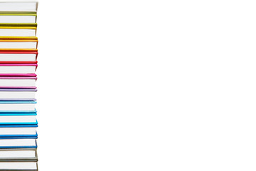 Books. A lot of books with bright covers in one pile isolated on white background. Place for text. Design element, paper and leather texture. Colorful books on the shelf, close up