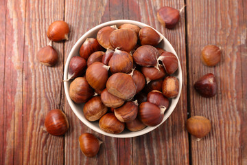 raw chestnut on wood background