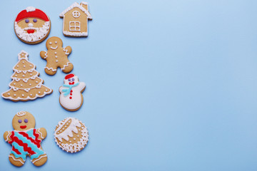 Christmas gingerbread cookies set on a blue background, with copy space.