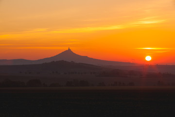 The silhouette of Hazmburk Castle at sunrise.Czech Republic.
