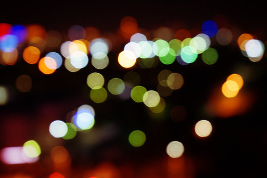 Abstract background of multi-colored glowing lights. Night city light blur.