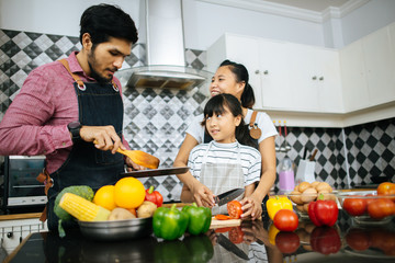 Family cooking time : Happy family help cooking meal together in kitchen at home..