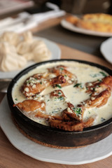 Chicken in a creamy sauce with garlic and herbs, khinkali. 