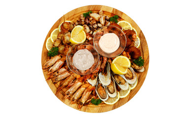 Shrimps, mussels, oysters on a wooden plate