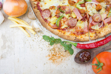 pizza and ingredient on wooden table