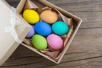 colorful eggs in brown gift box, easter eggs, soft focus
