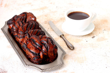 Yeast cake with chocolate and hot coffee