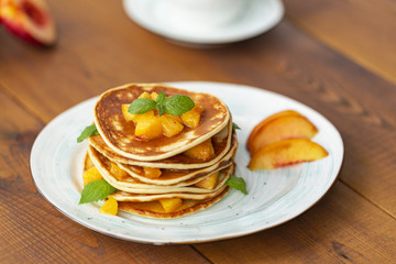 Pancakes with honey and fruit. Delicious breakfast.
