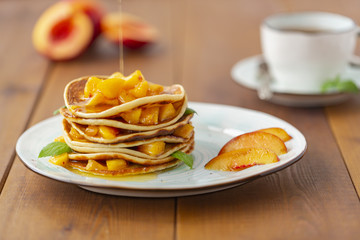 Pancakes with honey and fruit. Delicious breakfast.