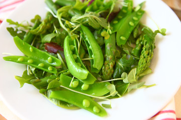 Spring salad with asparagus, snap peas and daikon sprouts