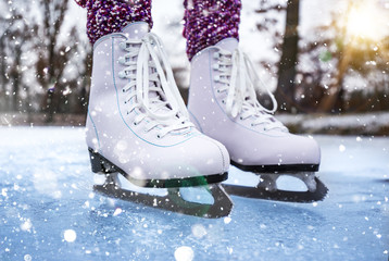Close-up of woman ice skating on a pond.
