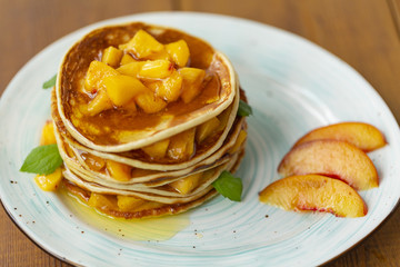 Pancakes with honey and fruit. Delicious breakfast.