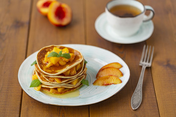 Pancakes with honey and fruit. Delicious breakfast.