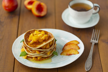 Pancakes with honey and fruit. Delicious breakfast.