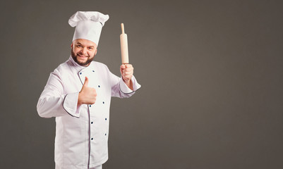 Funny cheerful chef in white uniform on a background for text.