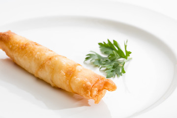 One Cigar pastry on a white plate.